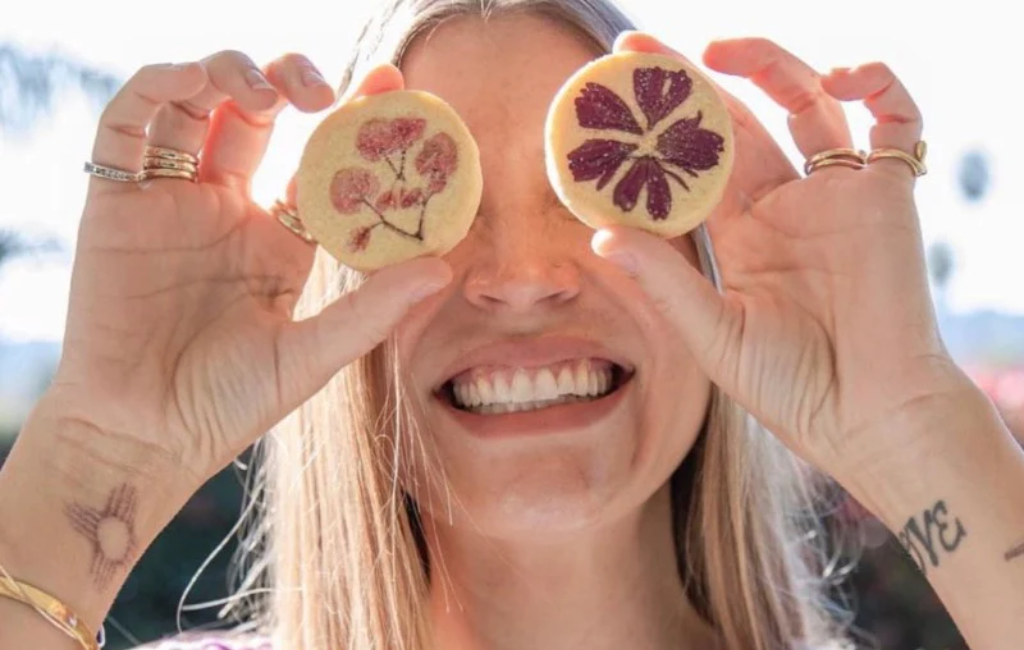 a model holding eat your flowers shortbread