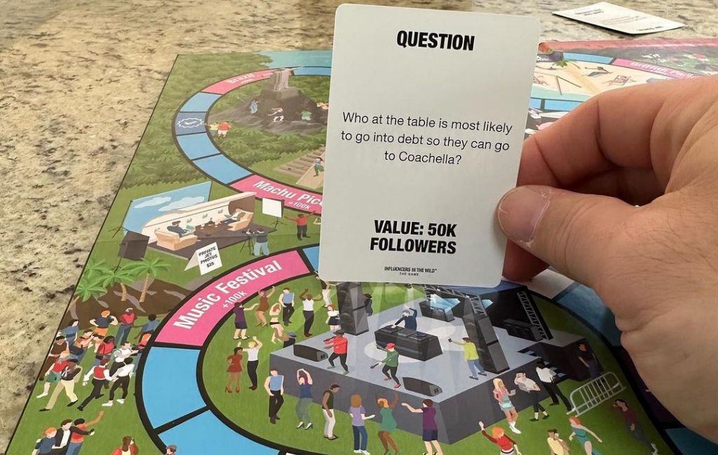 holding a card from influencers in the wild board game