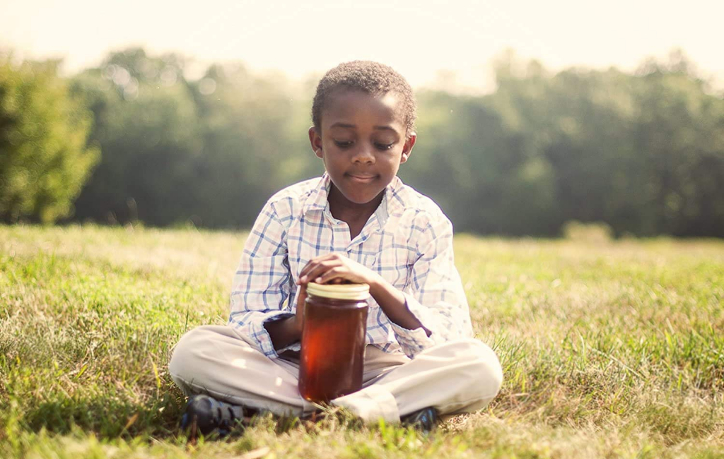 kid holding honey jar