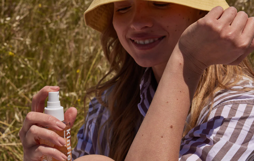 a girl using kinfield skincare outdoor