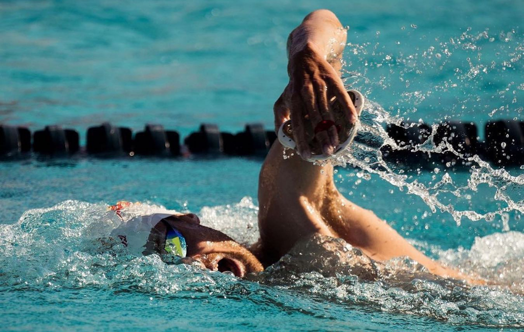 men swimming in pool