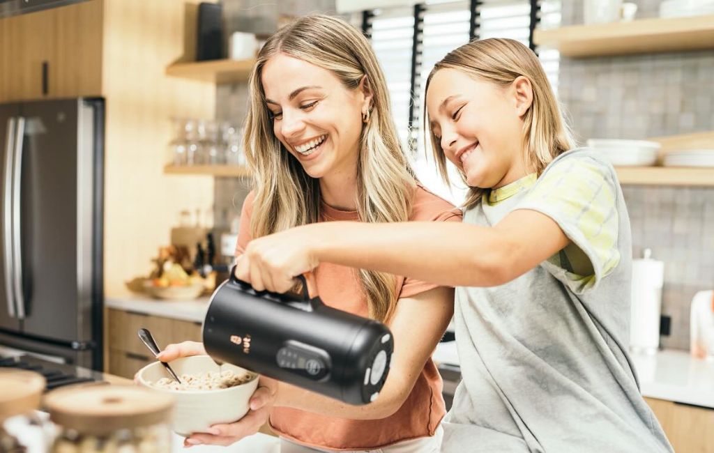 mom and son pouring milk on cereal using nutr machine