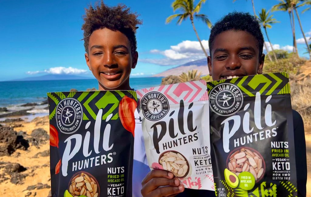 children-holding-pili-hunters-nuts