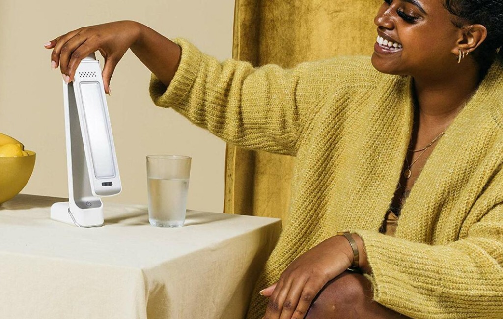 a woman using circadian optics therapy lamps