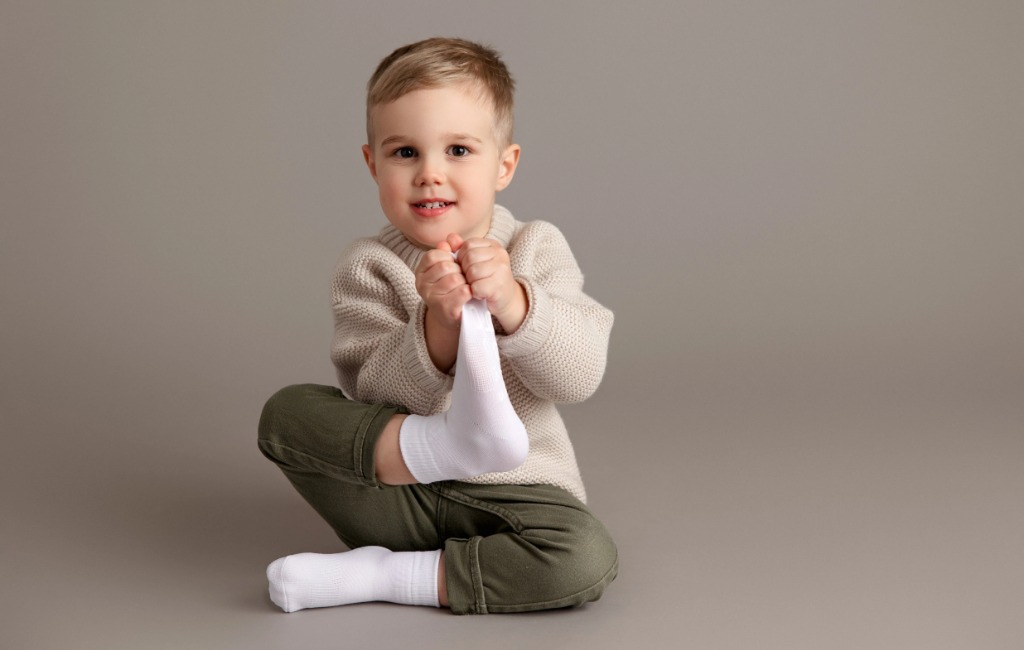 a boy wearing squid socks in white