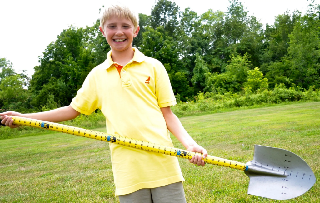 a-boy-holding-the-measuring-shovel