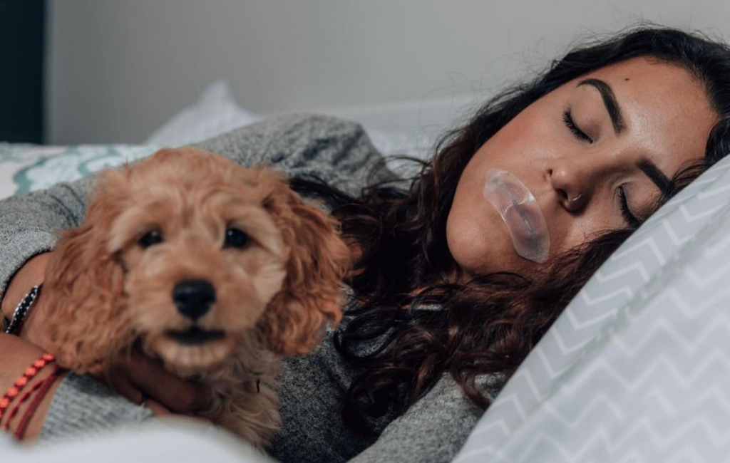 woman and dog in bed