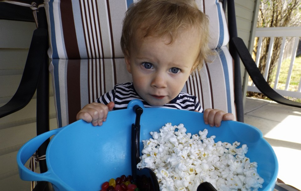 baby with popcorn bowl