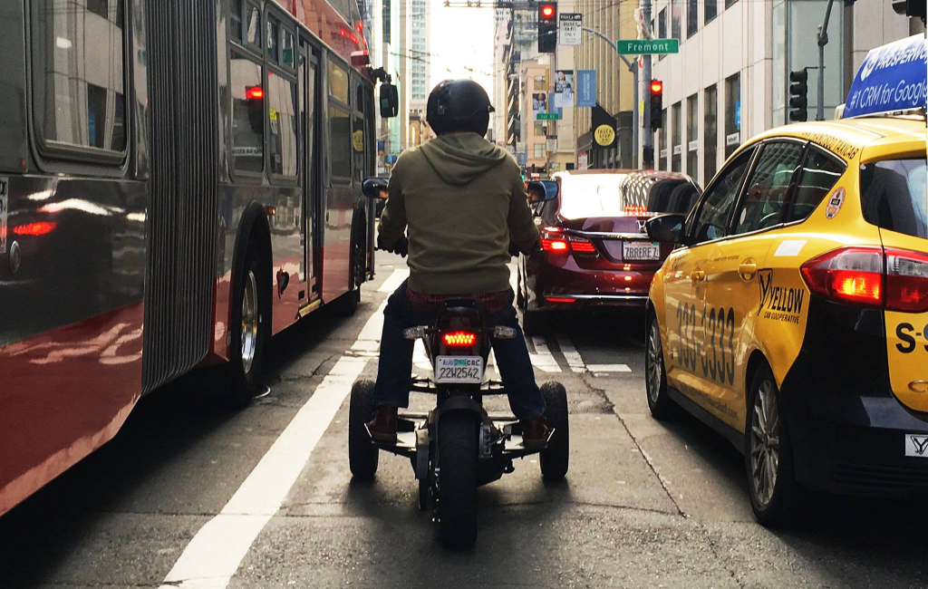 man driving motor in city