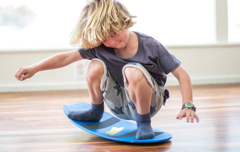 a-boy-playing-with-spooner-balance-board