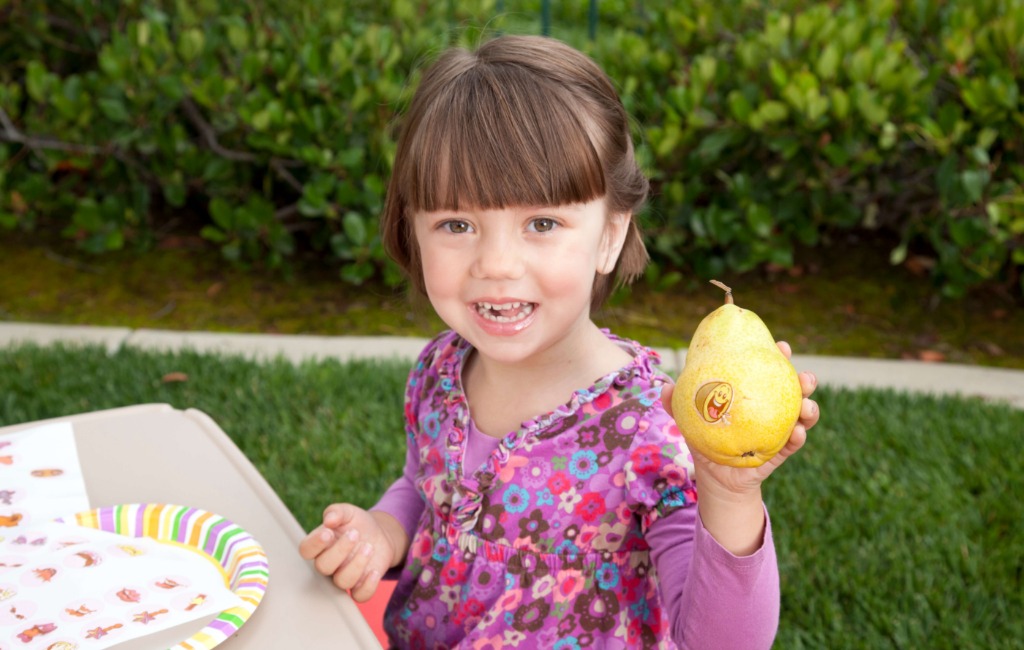 a-girl-holding-my-fruity-faces-edible-stickers