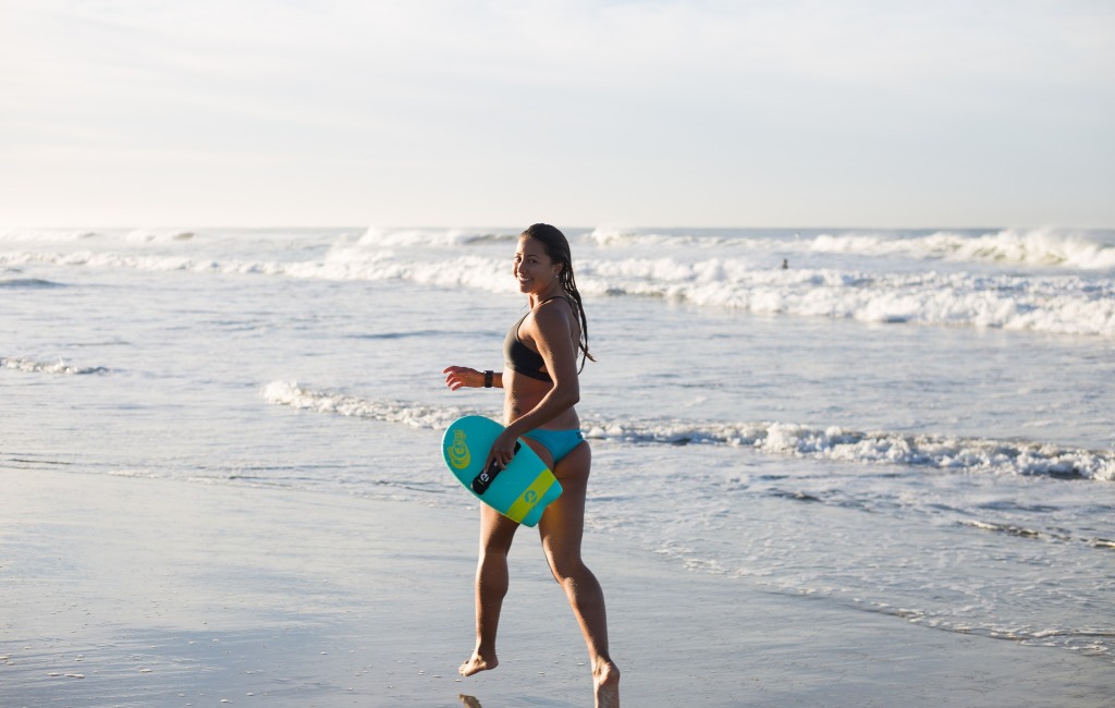 a-woman-holding-slyde-handboard