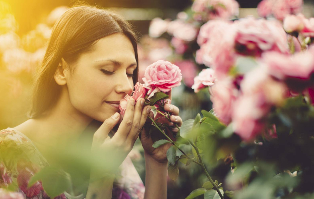 woman-smells-roses